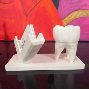 3D Printed White Tooth-Shaped Business Card Holder.
